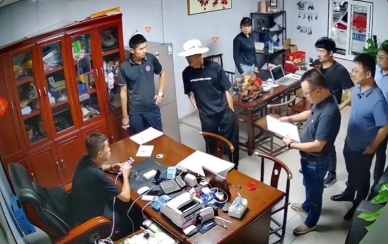7月初，狂飙兄弟（戴白帽者）一行人来到济南某二手车商处“打假”的场景。视频截图
